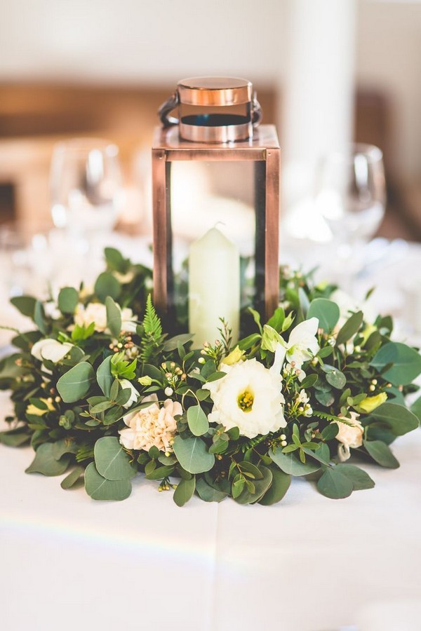 Copper lantern with church candle and greenery table centrepiece