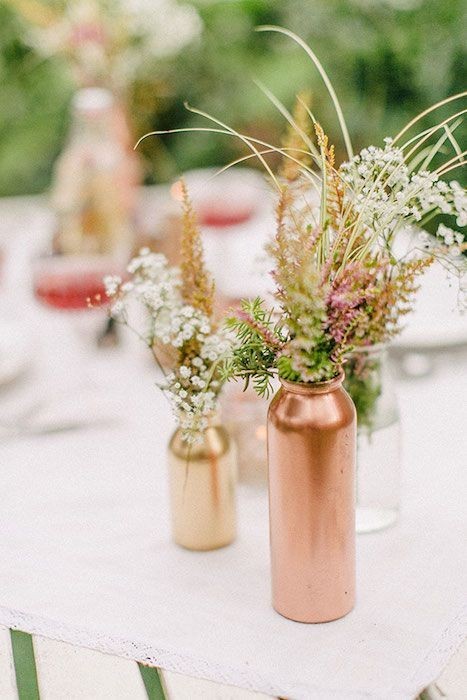 Mix painted copper, gold and clear bottles mismatched wedding centerpiece