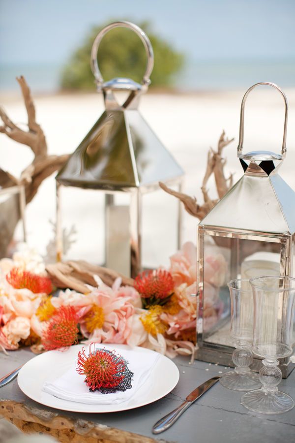 beach coral flowers and lantern wedding centerpiece