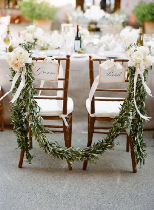 bride and groom chairs with garland and peach flowers
