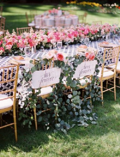 bride and groom chairs with lots of flower