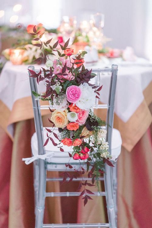 silver wedding chair with lots of flowers