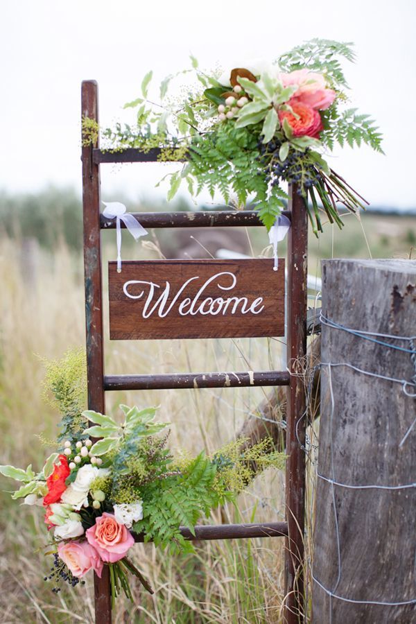 welcome sign ladder calligraphy sign ferns wedding florals