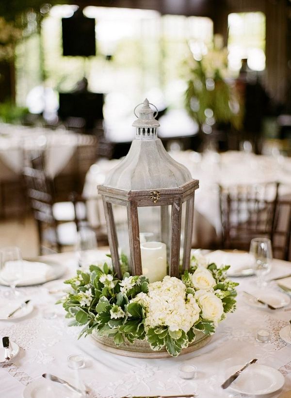 wood lantern and white flowers wedding centerpiece