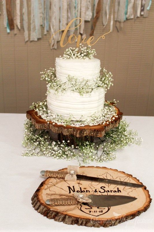 rustic buttercream wedding cake with tree stump and baby breath