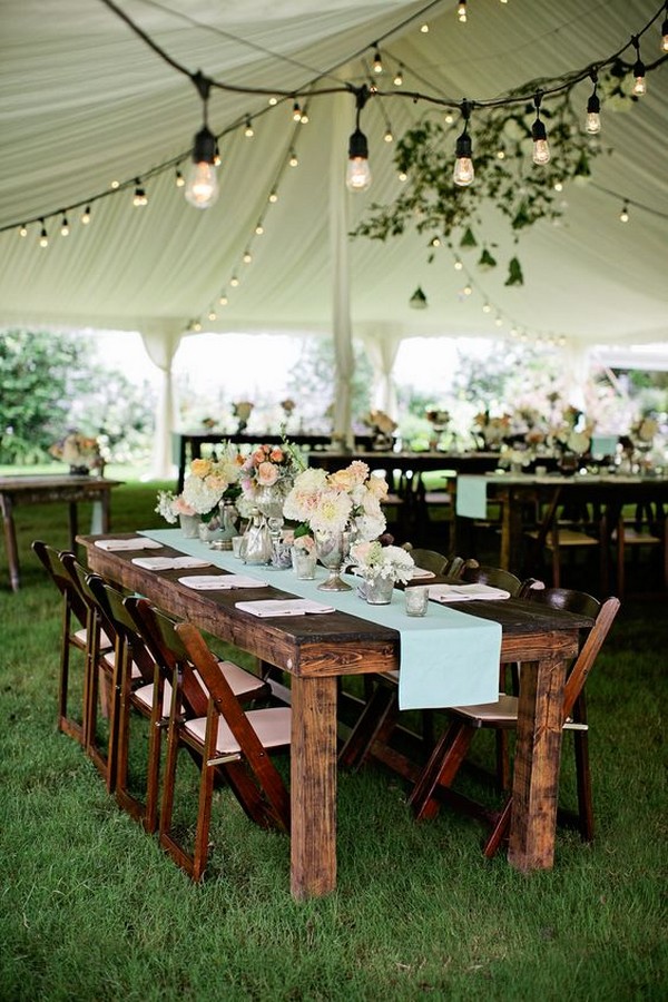 rustic wedding tent with draped fabric and lights