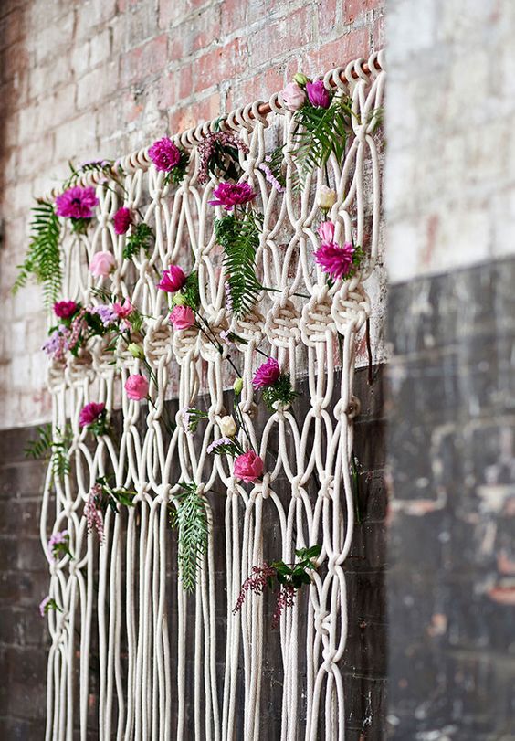 Bohemian macrame knotted backdrop with flowers