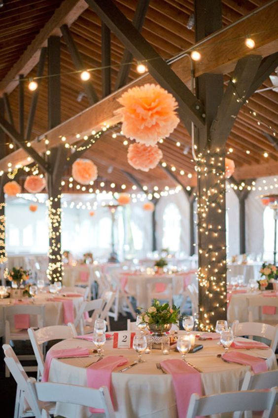 Combine fairylights with pom poms for a modern twist on a traditional wedding