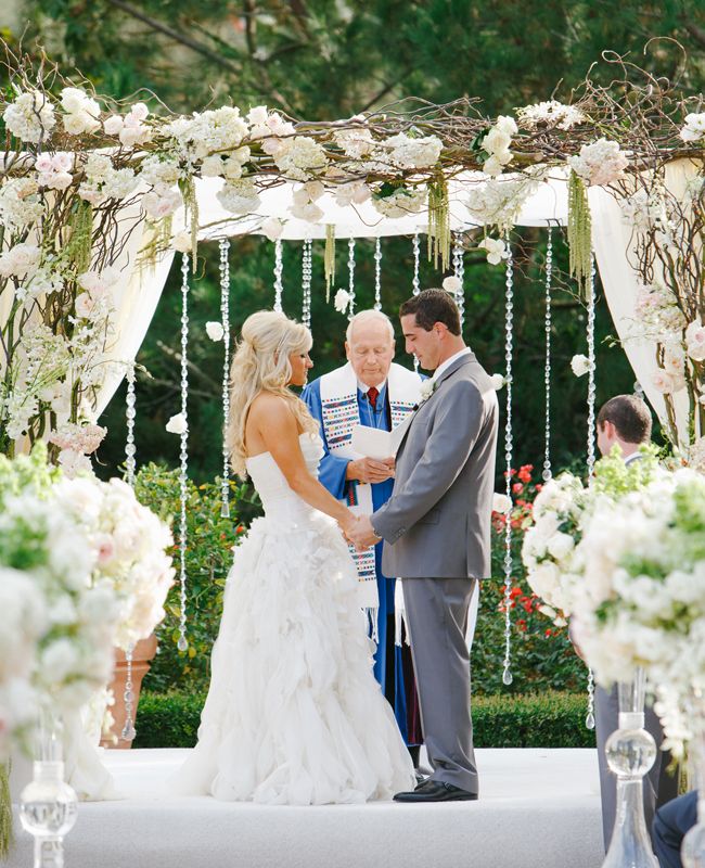 blush and white rose floral wedding archs with lights backdrop