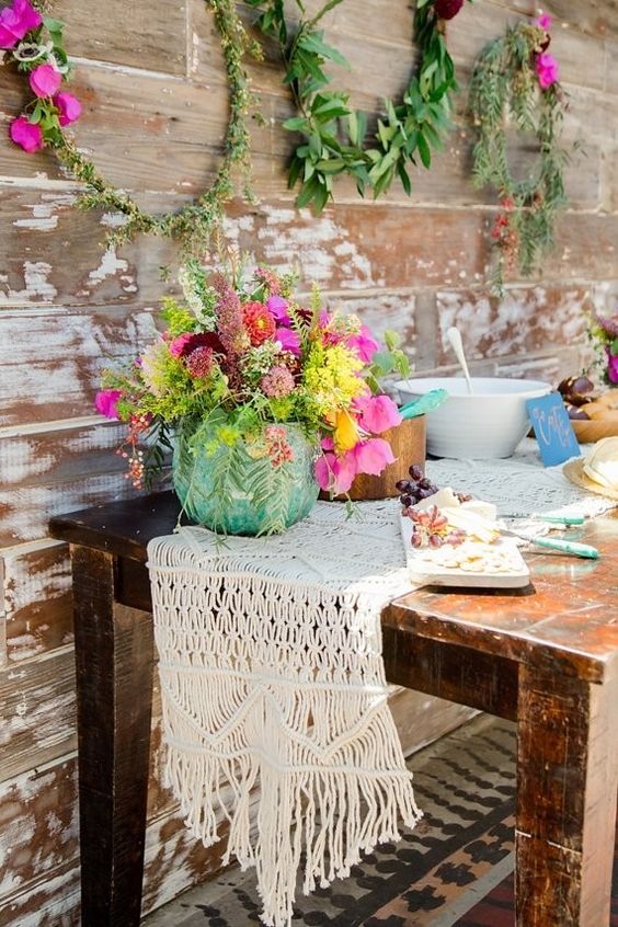 bohemian macrame wedding tabler runner with wildflowers centerpiece