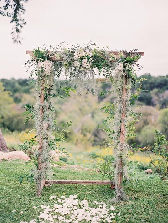 bohemian wedding arbor with daisies