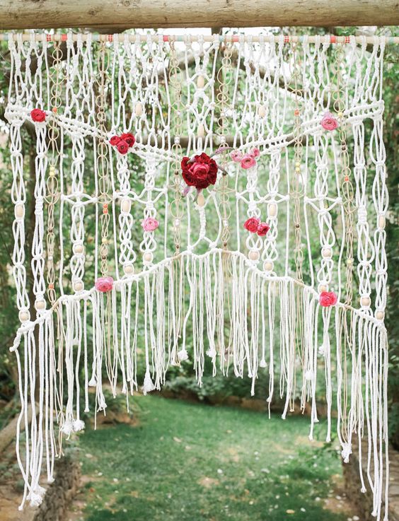 boho macrame ceremony backdrop with fresh flowers