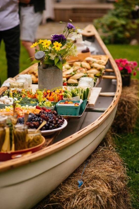 outdoor buffet in a canoe rustic wedding decor