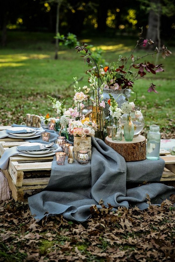 pallet picnic table using grey hessian burlap runner, filled with rustic decor elements, mercury votives, wood slabs and peach blooms in mix and match vases