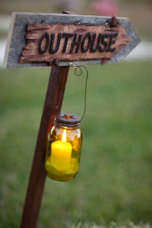 rustic outhouse wedding sign with candle and mason jar