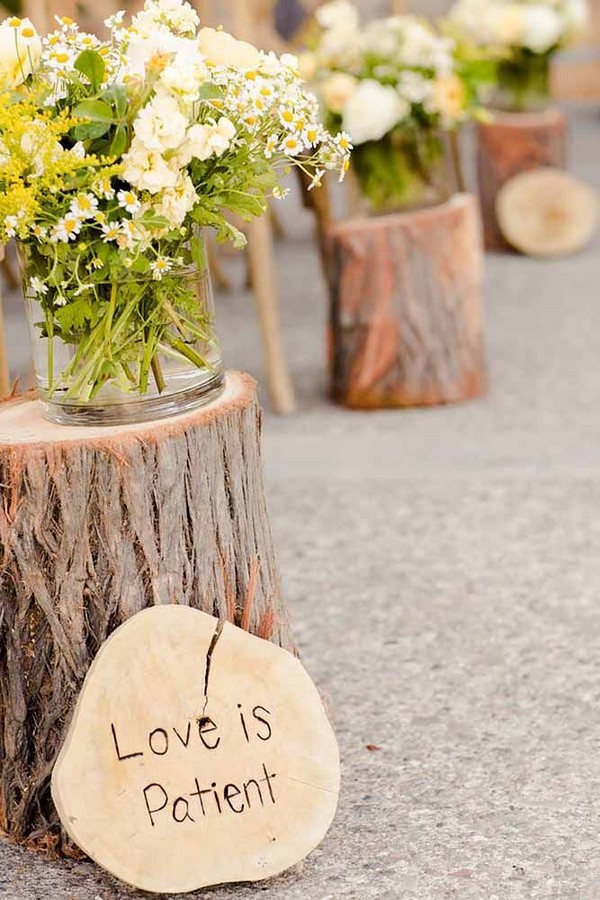 rustic tree stump wedding aisle decor with wooden wedding sign