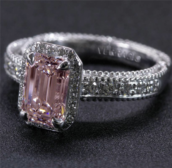 white gold emerald engagement ring with pink diamond