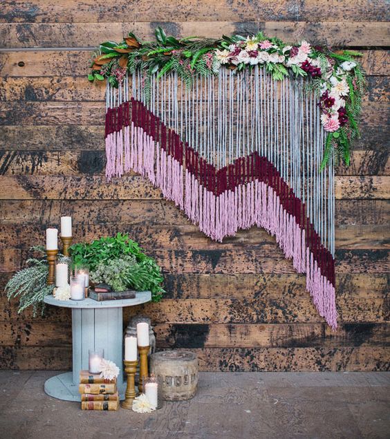 yarn wedding backdrop with floral accents