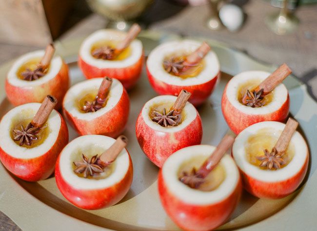 Apple cider in hollowed apples fall appetizer for rustic fall wedding