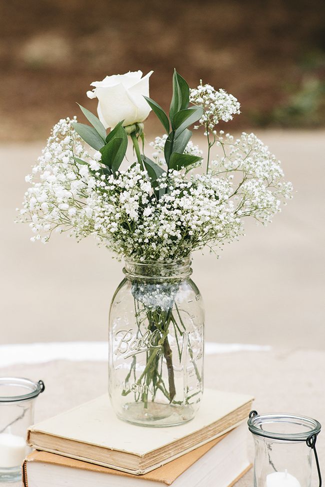 Baby's breath and roses in a mason jar—a simple, affordable wedding centerpiece