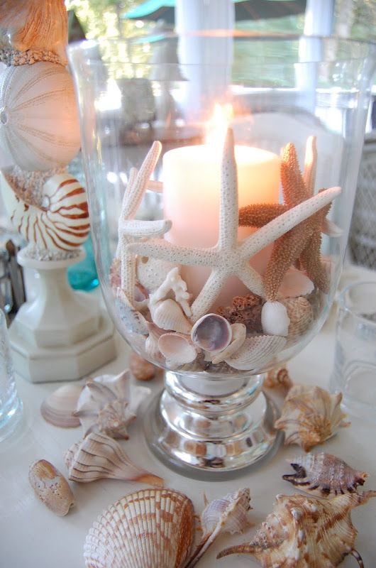 Beach themed table setting with shell candle as the centerpiece