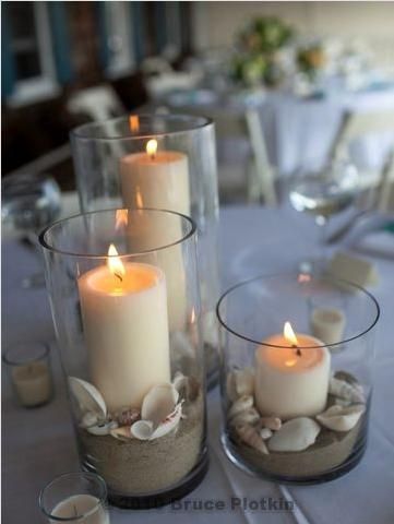 Beach wedding centerpiece with sand and candles