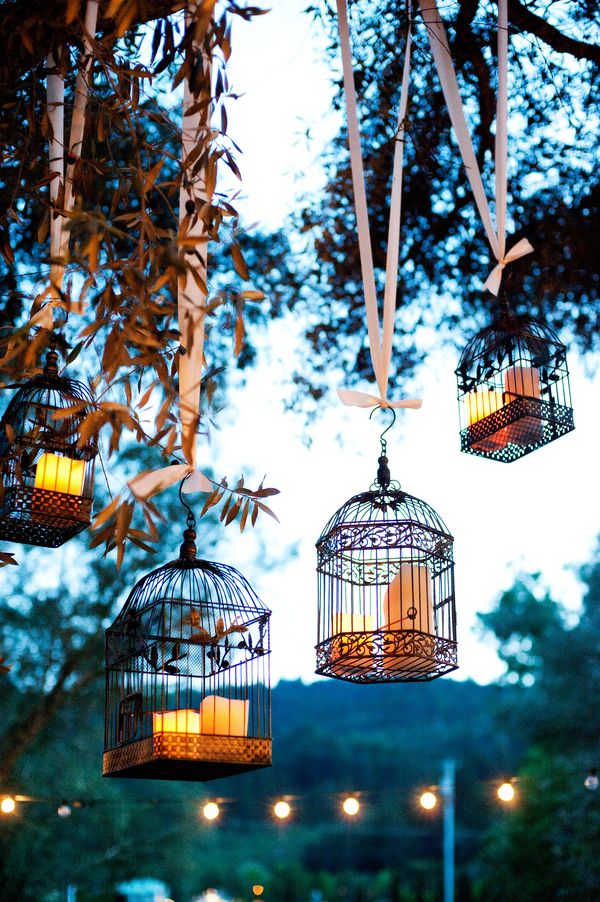 Candles in old bird cages for dusk atmosphere