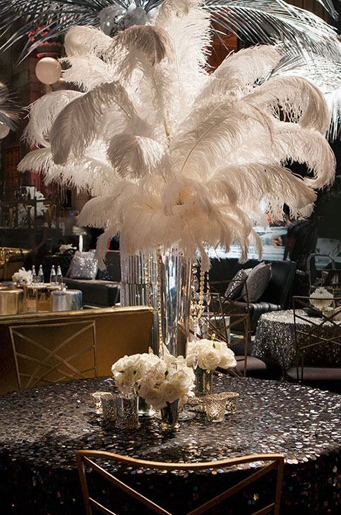 Great Gatsby inspired table wedding centerpiece featuring white feather