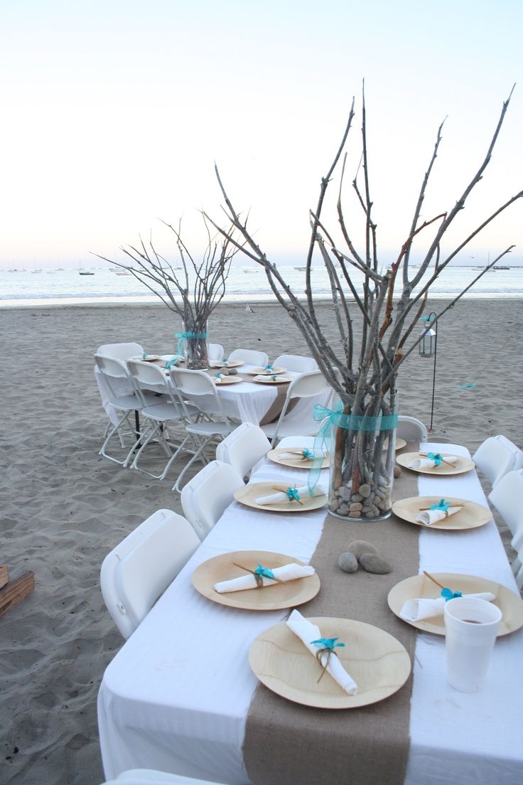 Pastel blues, rustic branches and simple setting for beach wedding