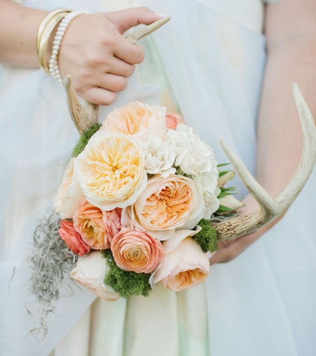 Pastel coral pink ranunculus bridal bouquet with deer antler