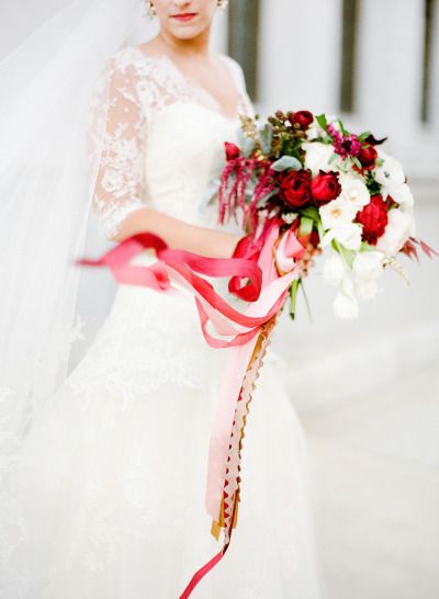 Romantic red and white bridal bouquet with ribbon