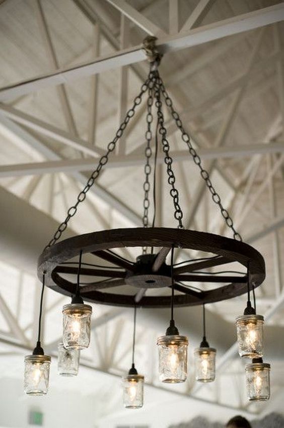 Wagon wheel chandeliers are gorgeous lighting for a barn wedding or rustic theme