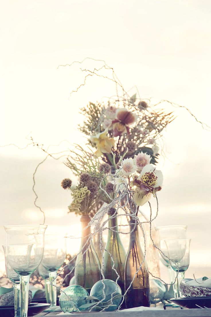 .beach wedding ideas- wine bottles with flowers