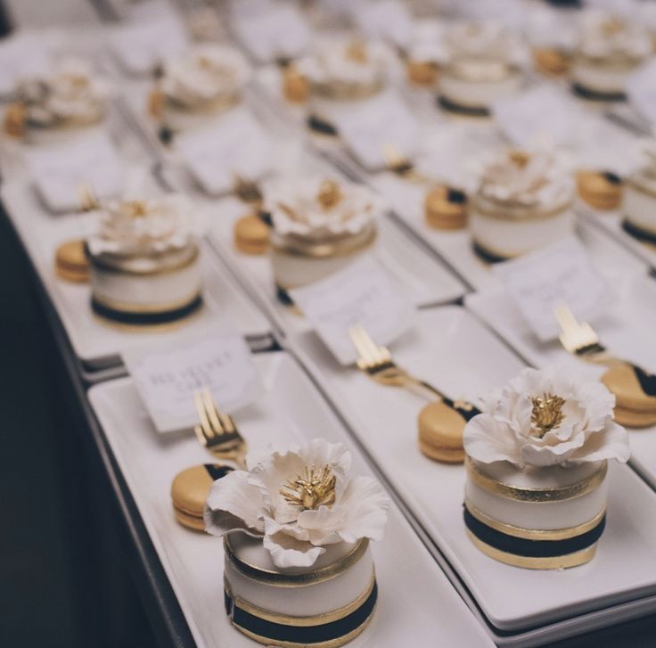 black white and gold mini wedding cakes with sugar flower topper