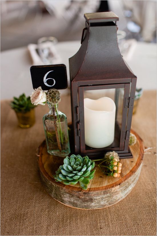 candle lit lantern centerpiece and chalkboard table number centerpiece