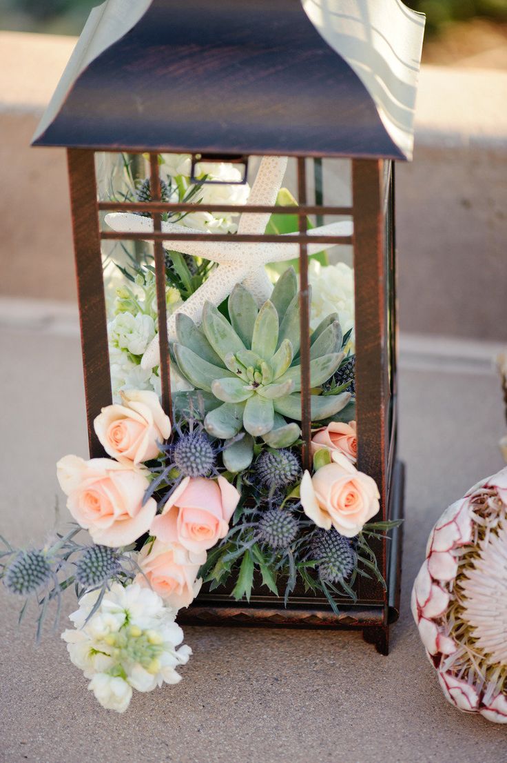 coral pink roses and succulent wedding centerpiece