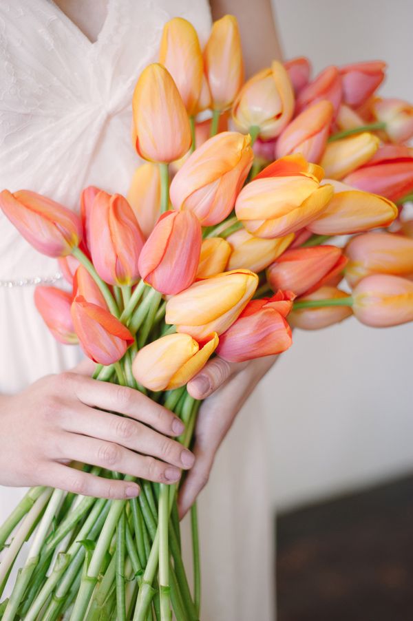 Deep pink wedding bouquet with roses, tulips and Anemones