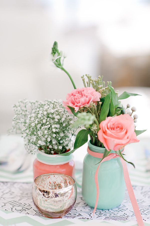 mint baby's breath and coral roses in mason jars wedding centerpieces