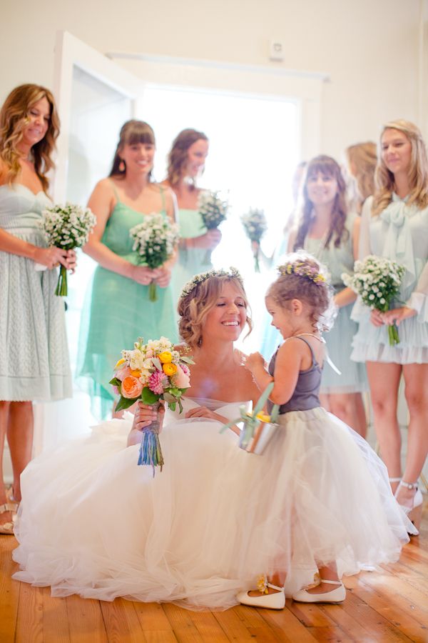 mismatched bridesmaid dresses and cute flower girl