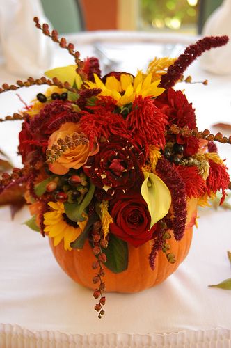 orange and red fall wedding ideas-use a pumpkin as a flower vase