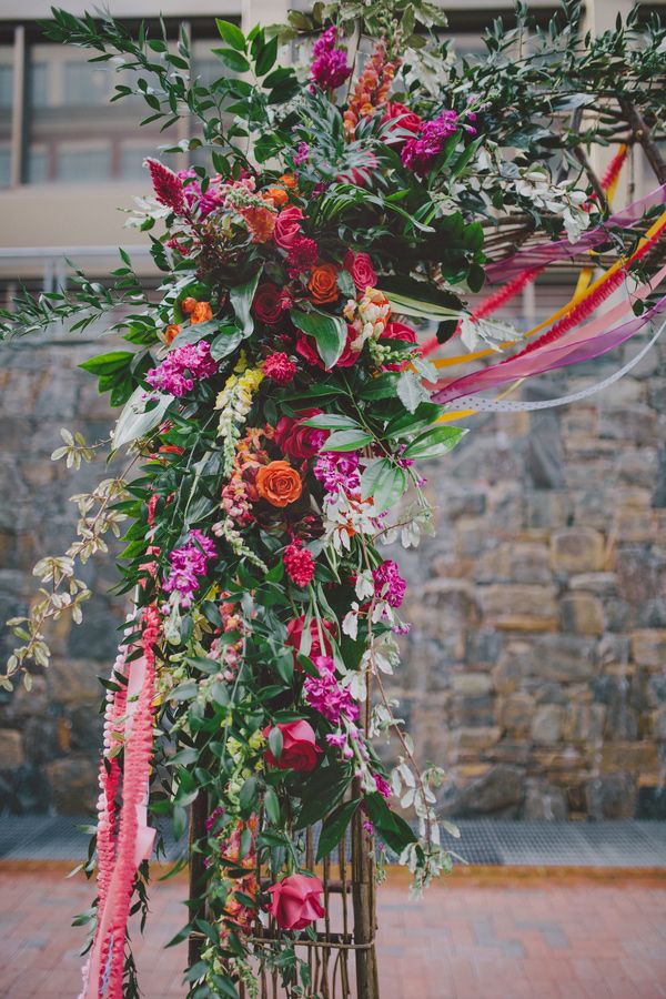 purple anf orange floral ceremony arch for fall wedding