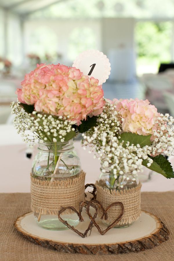 reception centerpieces featured burlap-covered mason jars filled with hydrangeas and baby's breath