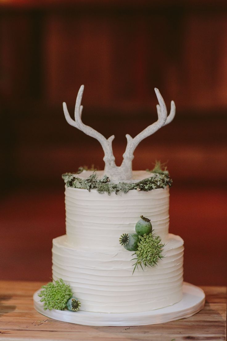 rustic simple white wedding cake with deer anlter cake topper