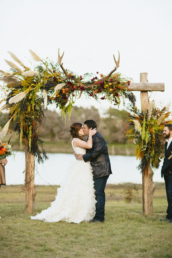 rustic wedding ceremony arch with antlers for fall wedding