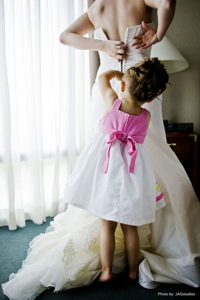 the littlest member of the wedding party helping the Bride get ready