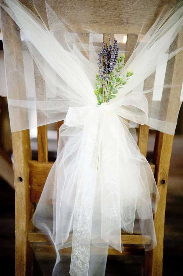 tulle draping with a few sprigs of lavender as a chair decoration