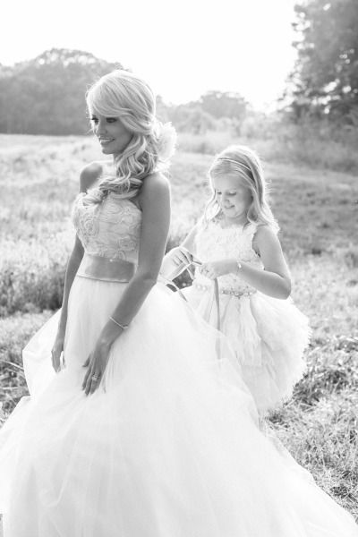 wedding shoot ideas -flower girl helps bride get ready for the big day