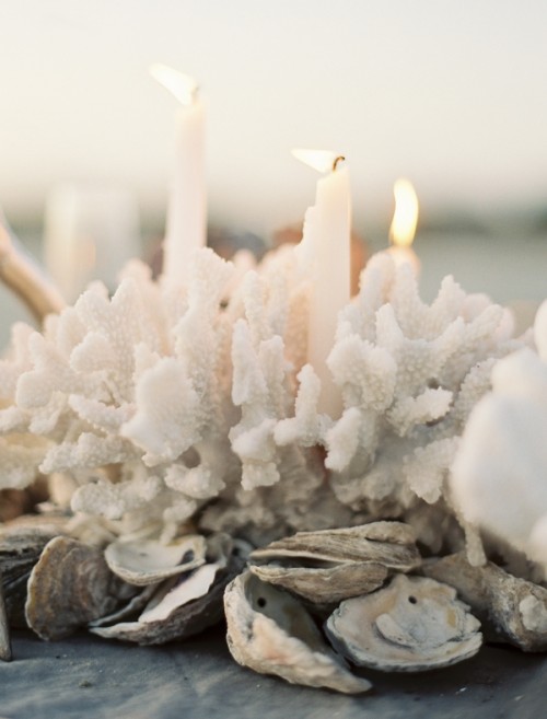 white coral beach wedding centerpiece with candle