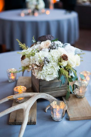 winter wonderland wedding antler centerpiece with tea lights and floral arrangement
