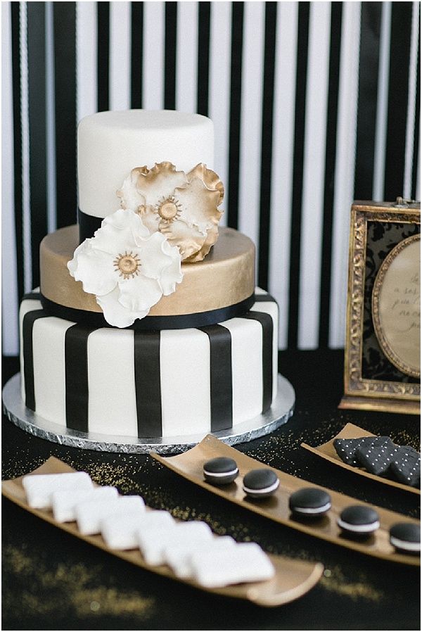Black and white wedding cake with gold accents